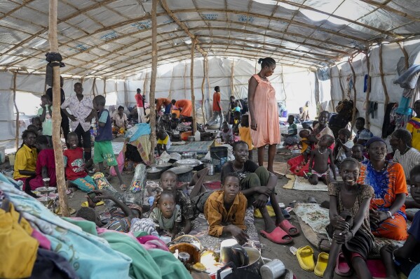 FILE - South Sudanese shelter in a transit center in Renk, South Sudan Wednesday, May 17, 2023. A top migration monitoring group says conflicts and natural disasters have led nearly 76 million people to be displaced within their countries in 2023, a new record, with violence in Sudan, Congo and the Middle East together driving two-thirds of the new movement.(AP Photo/Sam Mednick, File)