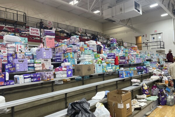 Diapers are stacked inside the gym at Indian Lake High on Saturday, March 16, 2024, in Indian Lake, Logan County, Ohio. The high school has become a donation center after a tornado swept through the Indian Lake area Thursday. in Indian Lake, in Logan County, Ohio. The Indian Lake area in Ohio’s Logan County was one of the hardest hit (AP Photo/Patrick Orsagos)