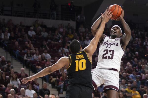 Texas A&M guard Tyrece Radford (23) shoots the ball over Missouri guard Nick Honor (10) in the first half of an NCAA college basketball game in College Station, Texas, Wednesday, Jan. 11, 2023. (Logan Hannigan-Downs/College Station Eagle via AP)