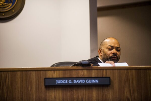 
              Genesee District Judge David Guinn authorizes charges Wednesday, June 14, 2017, in Flint, Mich., for Department of Health and Human Services Director Nick Lyon and Chief Medical Executive Dr. Eden Wells in relation to the Flint water crisis. Lyon is accused of failing to alert the public about an outbreak of Legionnaires' disease in the Flint area, which has been linked by some experts to poor water quality in 2014-15. Wells was charged with obstruction of justice and lying to a police officer. (Jake May/The Flint Journal-MLive.com via AP)
            