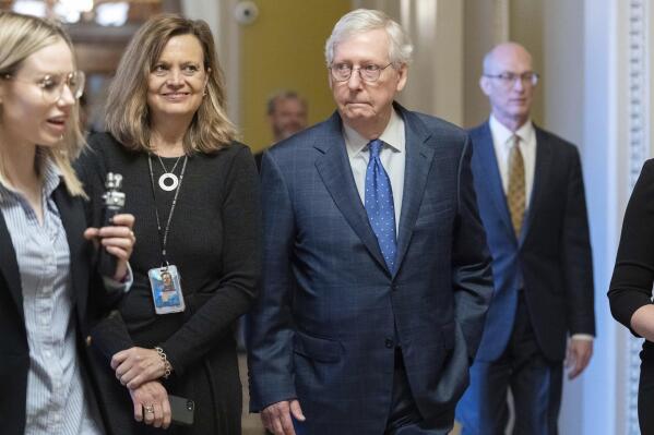 Senate Minority Leader Mitch McConnell, R-Ky., walks to his office as he talks to reporters on Capitol Hill in Washington, Tuesday, Jan. 3, 2023. (AP Photo/Jose Luis Magana)