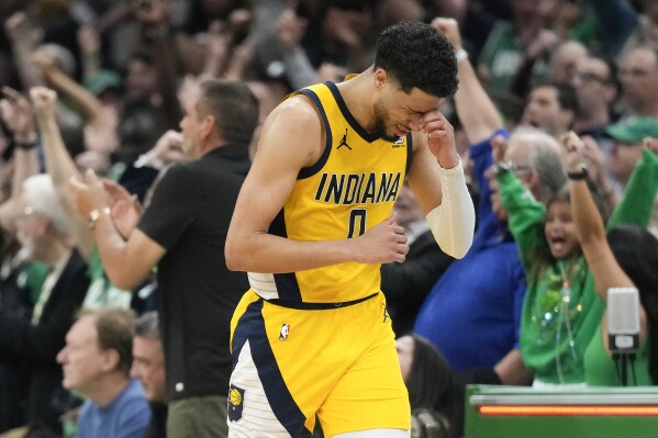 Indiana Pacers guard Tyrese Haliburton (0) reacts after missing a shot against the Boston Celtics to end regulation time in Game 1 of the NBA Eastern Conference basketball finals, Tuesday, May 21, 2024, in Boston. (AP Photo/Charles Krupa)