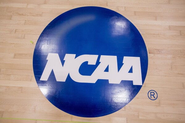 FILE - The new NCAA logo that was painted on the Concordia University Irvine basketball court is seen in Irvine, Calif., Friday, May 19, 2017. Prompted by new legislation emphasizing individual accountability in NCAA rules violations cases, the Committee on Infractions has outlined potential penalties for rules-breakers in leadership positions beyond the coaching staff, up to and including school presidents. (Paul Rodriguez/The Orange County Register via AP)