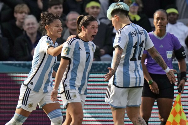 Argentina's Romina Nunez, center, celebrates scoring their second goal of the game during the Women's World Cup Group G soccer match between Argentina and South Africa in Dunedin, New Zealand, Friday, July 28, 2023. (AP Photo/Alessandra Tarantino)