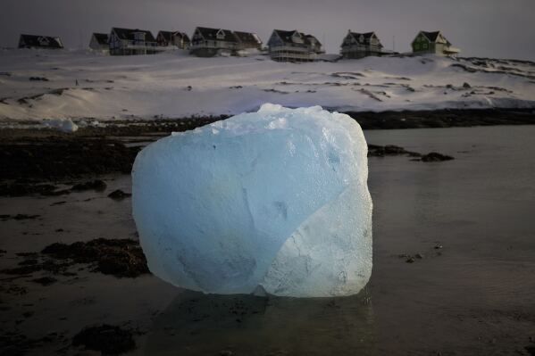 A piece of ice is photographed melting at the shore of a beach in Nuuk, Greenland, Friday, Feb. 14, 2025. (AP Photo/Emilio Morenatti)