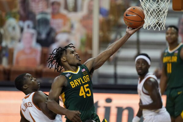 CORRECTS TO SECOND HALF, INSTEAD OF FIRST HALF - Baylor guard Davion Mitchell (45) drives to the basket past Texas guard Andrew Jones (1) during the second half of an NCAA college basketball game Tuesday, Feb. 2, 2021, in Austin, Texas. (AP Photo/Eric Gay)