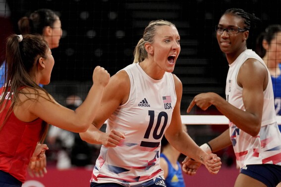 FILE - Team USA volleyball player Jordan Larson, center, celebrates with teammates Justine Wong-Orantes, left, and Foluke Akinradewo, right, after winning a point during the women's volleyball preliminary round pool B match between China and United States at the 2020 Summer Olympics in Tokyo, Tuesday, July 27, 2021, file photo. Three-time Olympian Jordan Larson will return to Nebraska to be a full-time assistant, coach John Cook announced Tuesday, June 13, 2023. Larson starred at Nebraska from 2005-08 before excelling on the international level. (AP Photo/Frank Augstein, File)