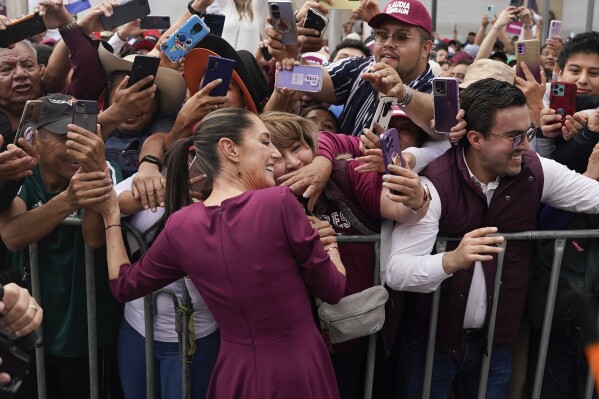 Presidential candidate Claudia Sheinbaum greets supporters upon her arrival to her opening campaign rally at the Zocalo in Mexico City, Friday, March 1, 2024. General Elections are set for June 2. (AP Photo/Aurea Del Rosario)