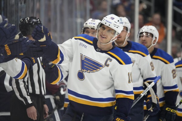 St. Louis Blues center Brayden Schenn is congratulated for his goal against the Colorado Avalanche during the third period of an NHL hockey game Saturday, Nov. 11, 2023, in Denver. (AP Photo/David Zalubowski)