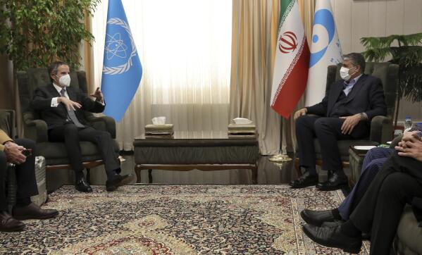 FILE - International Atomic Energy Organization, IAEA, Director General Rafael Mariano Grossi, left, speaks with Head of Atomic Energy Organization of Iran Mohammad Eslami during their meeting in Tehran, on March 5, 2022. As the war in Ukraine rages on, diplomats trying to salvage the languishing 2015 Iran nuclear deal have been forging ahead with negotiations despite distractions caused by the conflict. (AP Photo/Vahid Salemi, File)