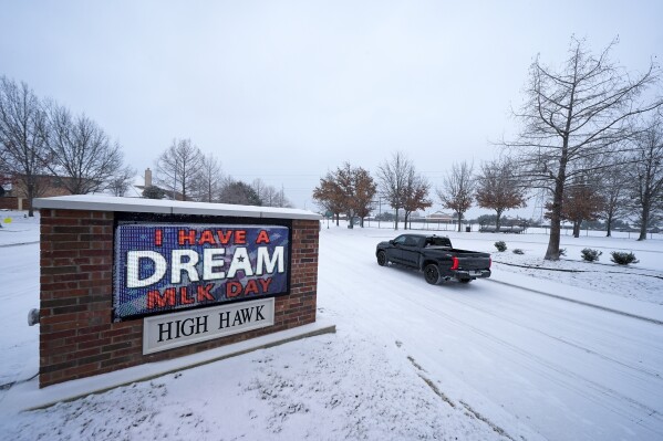 A sign near the entrance to the High Hawk community in Grand Prairie, Texas, shows a message honoring Martin Luther King Jr. Day during a winter storm, Monday, Jan. 15, 2024, in Grand Prairie, Texas. (AP Photo/Julio Cortez)