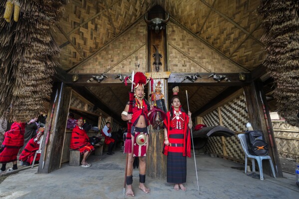 Indigenous Naga tribals stand dressed in their traditional outfit during the Hornbill Festival in Kisama, on the outskirts of Kohima, capital of the northeastern Indian state of Nagaland, Tuesday, Dec. 10, 2024. (AP Photo/Anupam Nath)