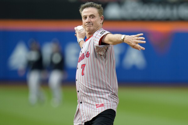 St. John's men's basketball coach Rick Pitino throws out a ceremonial first pitch before a baseball game between the New York Mets and the New York Yankees Tuesday, June 13, 2023, in New York. (AP Photo/Frank Franklin II)