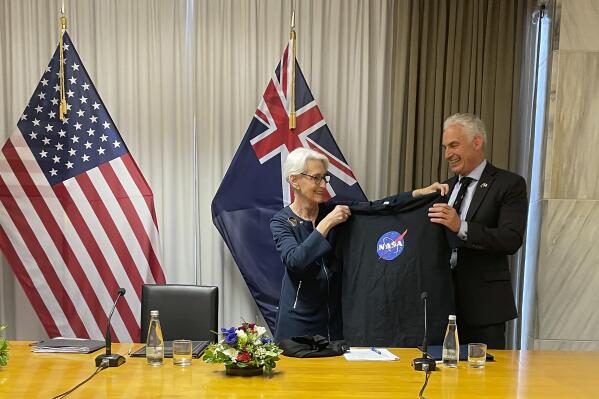 U.S. Deputy Secretary of State Wendy Sherman, left, hands New Zealand Economic and Regional Development Minister Stuart Nash a NASA t-shirt Tuesday, Aug. 9, 2022, during an agreement-signing event in Wellington, New Zealand. The United States is doubling down on its investment in the Pacific, said Sherman on Tuesday as she concluded a five-nation visit to the region. (AP Photo/Nick Perry)