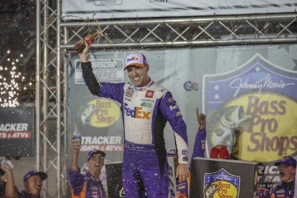 Denny Hamlin celebrates in Victory Lane with the team after winning the NASCAR Cup Series auto race at Bristol Motor Speedway on Saturday night, Sept. 16, 2023, in Bristol, Tenn. (Emily Ball/Bristol Herald Courier via AP)
