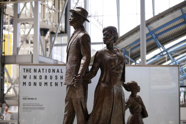 A vies of National Windrush Monument unveiled at Waterloo Station in London, Wednesday, June 22, 2022. The unveiling of the statue - of a man, woman and child in their Sunday best standing on top of suitcases on Wednesday will mark Windrush Day. (John Sibley/Pool Photo via AP)