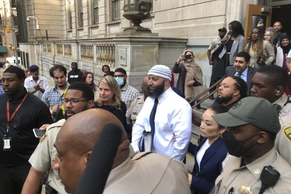 FILE - Adnan Syed, center, leaves the Elijah E. Cummings Courthouse on Sept. 19, 2022, in Baltimore. Syed’s lawyer has asked Maryland’s highest court Wednesday, May 24, 2023, to overturn a lower court’s ruling that reinstated his murder conviction from more than two decades ago - after he was freed last year in a legal case that gained international attention from the hit podcast “Serial.” (AP Photo/Brian Witte, File)