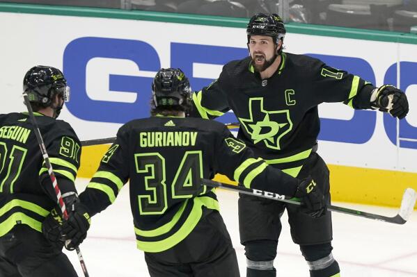 Dallas Stars left wing Jamie Benn (14) celebrates his goal with teammates Tyler Seguin (91) and Denis Gurianov (34) during the third period of the team's NHL hockey game against the Florida Panthers in Dallas, Thursday, Jan. 6, 2022. The Stars won 6-5 in a shootout. (AP Photo/LM Otero)