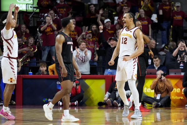 Iowa State forward Robert Jones (12) celebrates in front of Houston guard L.J. Cryer (4) at the end of an NCAA college basketball game, Tuesday, Jan. 9, 2024, in Ames, Iowa. Iowa State won 57-53. (AP Photo/Charlie Neibergall)