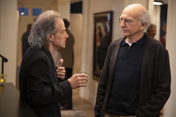 This image released by HBO shows Richard Lewis, left, with Larry David in a scene from Season 10 of "Curb Your Enthusiasm." Lewis, an acclaimed comedian known for exploring his neuroses in frantic, stream-of-consciousness diatribes while dressed in all-black, leading to his nickname 鈥淭he Prince of Pain,鈥� has died. He was 76. He died at his home in Los Angeles on Tuesday night after suffering a heart attack, according to his publicist Jeff Abraham. (John P. Johnson/HBO via 麻豆传媒app)