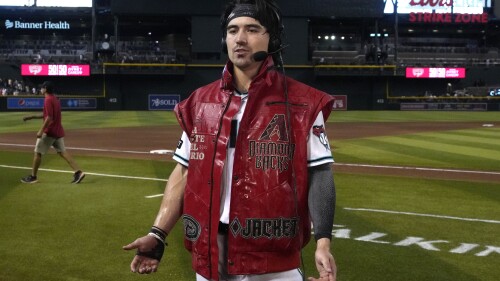 Arizona Diamondbacks' Corbin Carroll wears the "victory vest" after hitting a walkoff RBI single against the Pittsburgh Pirates in the 10th inning during a baseball game, Saturday, July 8, 2023, in Phoenix. (AP Photo/Rick Scuteri)