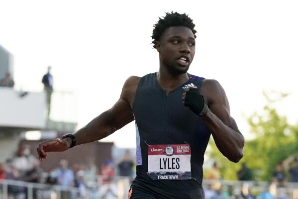 Noah Lyles competes in the second semi-final of the men's 100-meter run at the U.S. Olympic Track and Field Trials Sunday, June 20, 2021, in Eugene, Ore. In first notable demonstration of the track trials, Lyles made a subtle gesture, wearing a black glove — minus the fingers on his left hand, and raising his fist when he was introduced before the race. (AP Photo/Ashley Landis)