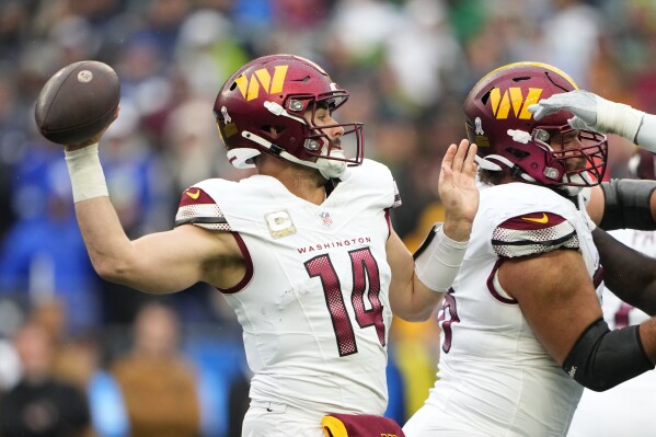 Washington Commanders quarterback Sam Howell (14) passes in the first half of an NFL football game against the Seattle Seahawks in Seattle, Sunday, Nov. 12, 2023. (AP Photo/Lindsey Wasson)