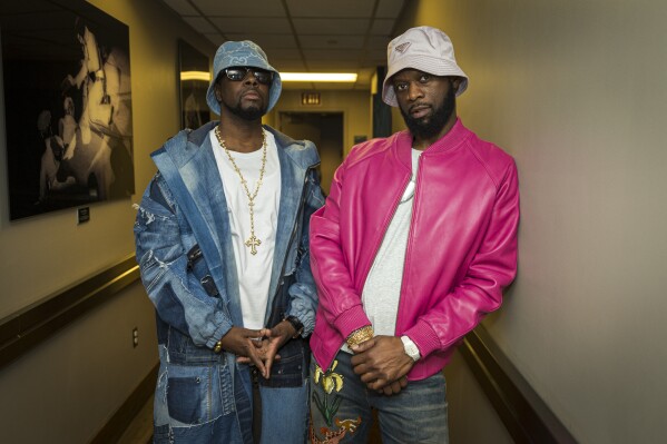 Wyclef Jean, left and Prakazrel “Pras” Michel, of The Fugees, pose for a portrait backstage during "The Miseducation of Lauryn Hill" 25th anniversary tour on Sunday, Nov. 5, 2023, at the Kia Forum in Inglewood, Calif. (Photo by Willy Sanjuan/Invision/AP)