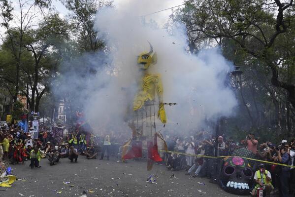 Residents gather to watch the burning of a cardboard figure representing Judas at the Santa María La Ribera Cultural Center, in Mexico City, Saturday, April 8, 2023. Every Holy Saturday Mexicans prepare for the traditional "Burning of Judas". During this activity on the sidelines of the Catholic Church's Holy Week celebrations, people gather in neighborhoods across the country to burn cardboard figures of Judas representing the embodiment of evil. (AP Photo/Marco Ugarte)