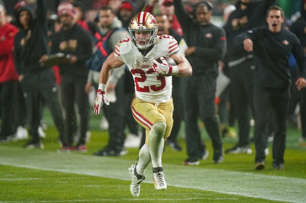 San Francisco 49ers running back Christian McCaffrey runs with the ball after making a catch against the Philadelphia Eagles during the second half of an NFL football game, Sunday, Dec. 3, 2023, in Philadelphia. (AP Photo/Chris Szagola)