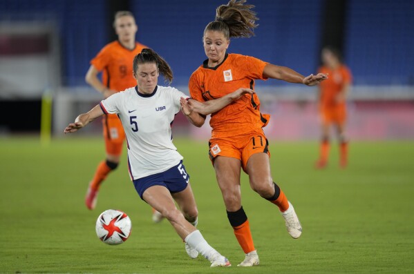 FILE - United States' Kelley O'Hara, left, and Netherlands' Lieke Martens battle for the ball during a women's quarterfinal soccer match at the 2020 Summer Olympics, Friday, July 30, 2021, in Yokohama, Japan. (AP Photo/Silvia Izquierdo, File)