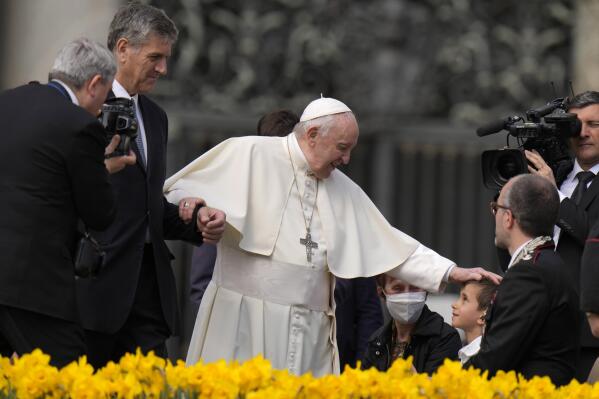 Pope Francis caresses a child at the end of his weekly general audience in St. Peter's Square, at the Vatican, Wednesday, April 20, 2022. (AP Photo/Alessandra Tarantino)