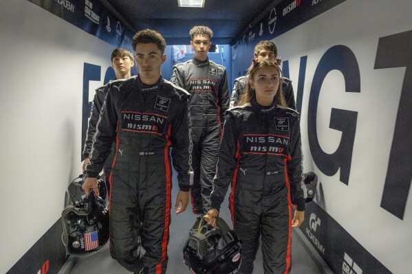 This image released by Columbia Pictures shows, from left, Sang Heon Lee, Darren Barnet, Archie Madekwe, Emelia Hartford and Pepe Barroso Silva in a scene from "Gran Turismo." (Gordon Timpen/Columbia Pictures/Sony Entertainment via AP)