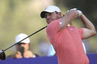 FILE - Rory McIlroy of Northern Ireland tees off at the 18th hole during DP World Tour Championship in Dubai, United Arab Emirates, on Nov. 19, 2022. McIlroy was one of the most vocal critics of the LIV Golf breakaway league last year. It left him feeling mentally drained so he decided to put his clubs away for a few weeks around Christmas. Now he’s back and appears to be as fiery as ever as he prepares to play the Dubai Desert Classic. (AP Photo/Martin Dokoupil, File)