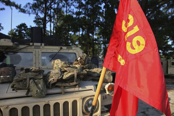 A flag representing the 82nd Airborne Division's 1-319th Field Artillery Regiment hangs from a Humvee in a remote location on Fort Bragg, N.C. on Wednesday, August 26, 2020. Days after learning of Staff Sergeant Jason Lowe's suicide, his unit started three weeks of field training. Chaplains visited soldiers to offer counseling and support. (AP Photo/Sarah Blake Morgan)
