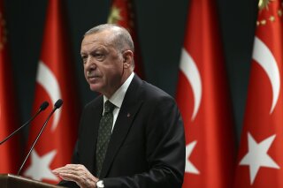 Turkey's President Recep Tayyip Erdogan speaks following a cabinet meeting in Ankara, Turkey, Tuesday, Nov. 17, 2020. Turkey is re-introducing a series of restrictions, including partial weekend lockdowns, in a bid to slow the surge of COVID-19 cases in the country. (Turkish Presidency via AP, Pool)