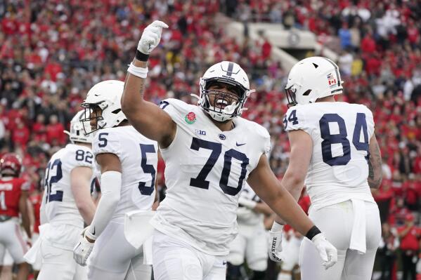 FILE - Penn State offensive lineman Juice Scruggs (70) celebrates a touchdown by Mitchell Tinsley during the first half in the Rose Bowl NCAA college football game against Utah Monday, Jan. 2, 2023, in Pasadena, Calif. Penn State coach James Franklin believes major college football players will inevitably be paid, and the sooner it happens the better it will be for all involved with the sport. (AP Photo/Mark J. Terrill, File)