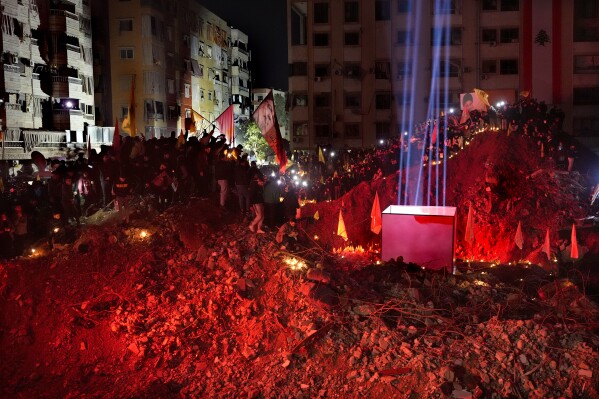 People gather at the site where former Hezbollah leader Sayyed Hassan Nasrallah was killed by Israeli airstrikes late September during a memorial ceremony in Dahiyeh, in the southern suburb of Beirut, Lebanon, Saturday, Nov. 30, 2024. (AP Photo/Hussein Malla)