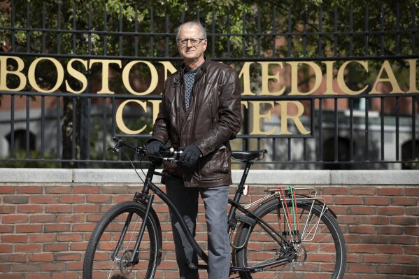 In this Saturday, May 9, 2020, photo, attorney Clyde Bergstresser poses outside Boston Medical Center in Boston. During a storied legal career, Bergstresser has become one of the go-to medical malpractice lawyers in Massachusetts. But as COVID-19 cases surged at Boston area hospitals, Bergstresser found his sympathies aligning with the professions he has often fingered in million-dollar lawsuits. (AP Photo/Michael Dwyer)
