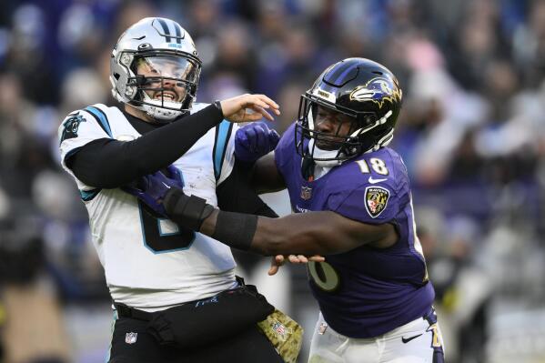 Carolina Panthers quarterback Baker Mayfield (6) gets hit by Baltimore Ravens linebacker Roquan Smith (18) after a pass in the second half of an NFL football game Sunday, Nov. 20, 2022, in Baltimore. (AP Photo/Nick Wass)