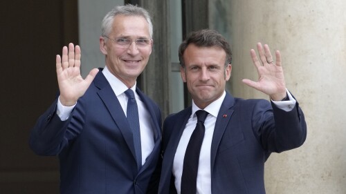 French President Emmanuel Macron, right, and NATO Secretary General Jens Stoltenberg wave before their talks Wednesday, June 28, 2023 at the Elysee Palace in Paris. NATO Secretary-General Jens Stoltenberg said earlier that he has called a meeting of senior officials from Turkey, Sweden and Finland on July 6 to try to overcome Turkish objections to Sweden joining the military organization. (AP Photo/Christophe Ena)