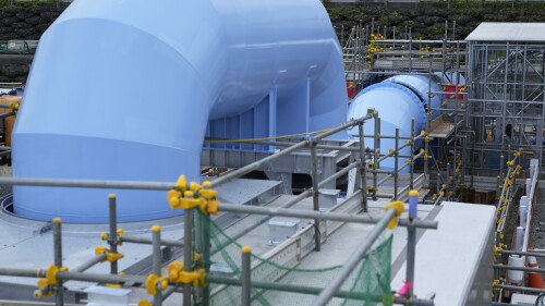 This photo taken during a tour for The Associated Press shows a blue pipeline to transport seawater, part of the facility for the release of treated radioactive water to sea from the Fukushima Daiichi nuclear power plant, operated by Tokyo Electric Power Company Holdings, also known as TEPCO, in Futaba town, northeastern Japan, Friday, July 14, 2023. (AP Photo/Hiro Komae)