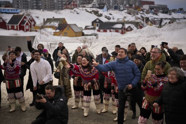 Relatives and family members throw rice at Salik and Malu Schmidt as they leave the church of our Savior after getting married in Nuuk, Greenland, Saturday, Feb. 15, 2025. (AP Photo/Emilio Morenatti)