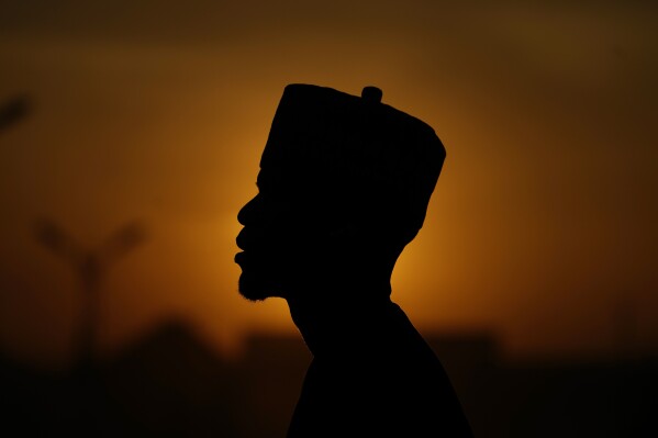An atheist stands against the sunset sky in Kano Nigeria Friday, July 14, 2023. Nonbelievers in Nigeria said they perennially have been treated as second-class citizens in the deeply religious country whose 210 million population is almost evenly divided between Christians dominant in the south and Muslims who are the majority in the north. Some nonbelievers say threats and attacks have worsened in the north since the leader of the Humanist Association of Nigeria, Mubarak Bala, was arrested and later jailed for blasphemy. (AP Photo/Sunday Alamba)