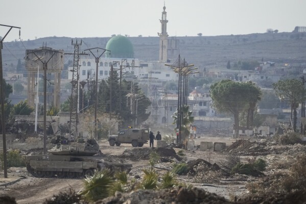 Israeli army armored vehicles block a road leading to the town of Quneitra, Syria, Jan. 5, 2025. (AP Photo/Mosa'ab Elshamy, File)