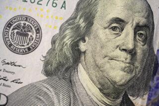 The likeness of Benjamin Franklin is seen on a U.S. $100 bill, Wednesday, Feb. 22, 2023, in Marple Township, Pa. In a time of high inflation and high interest rates, refunds for taxpayers are on average 10% smaller this year compared with last year, in part due to expired pandemic relief programs. (AP Photo/Matt Slocum)