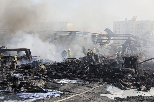 In this photo released by Uzbekistan's Emergency Ministry Press Service on Thursday, Sept. 28, 2023, firefighters work to extinguish a fire at a site of a warehouse in Tashkent, Uzbekistan. A massive explosion followed by a large blaze occurred early Thursday morning at a warehouse in the Uzbekistan capital Tashkent. (Uzbekistan's Emergency Ministry Press Service via AP)