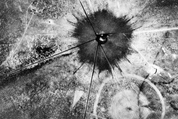 FILE - This July 16, 1945, photo shows an aerial view after the first atomic explosion at Trinity Test Site, N.M. U.S. senators from New Mexico and Idaho are making another push to expand the federal government’s compensation program for people exposed to radiation following uranium mining and nuclear testing carried out during the Cold War. Downwinders who live near the site where the world’s first atomic bomb was tested in 1945 as part of the top secret Manhattan Project would be among those added to the list. (AP Photo, File)