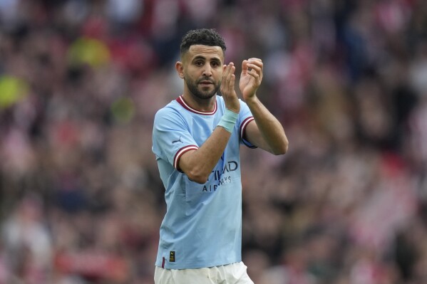 Manchester City's Riyad Mahrez applauds the fans after the end of the English FA Cup semifinal between Manchester City and Sheffield United at Wembley Stadium in London, Saturday, April 22, 2023. Riyad Mahrez is the latest Premier League player to head to Saudi Arabia after signing with Al-Ahli. The Algeria international was a key player in Leicester’s shocking title win in 2016 and then won the league four more times with Manchester City. (AP Photo/Alastair Grant)