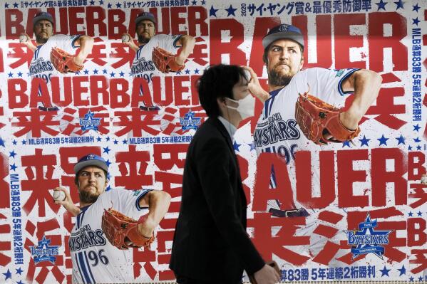 Posters of Trevor Bauer who's pitching for the Yokohama BayStars are placed at the pathway of a train station on Tuesday, May 2, 2023, in Yokohama near Tokyo. Bauer will pitch his first official game for the Yokohama DeNA BayStars on Wednesday and, to promote the start, a local department store is to unveil a seven-story poster of the former Cy Young winner on the building's facade. (AP Photo/Eugene Hoshiko)